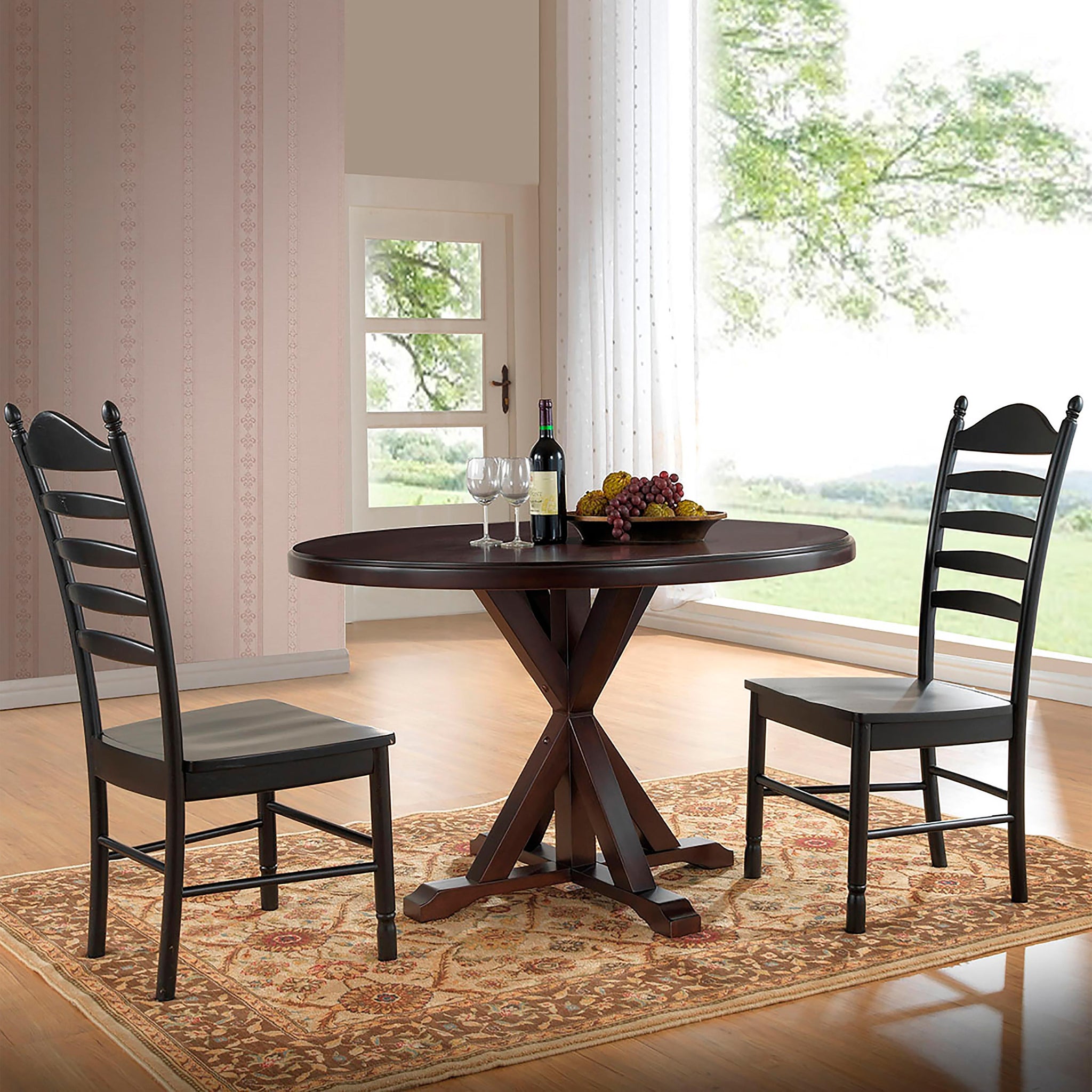 Round trestle dining table with matching wooden chairs.