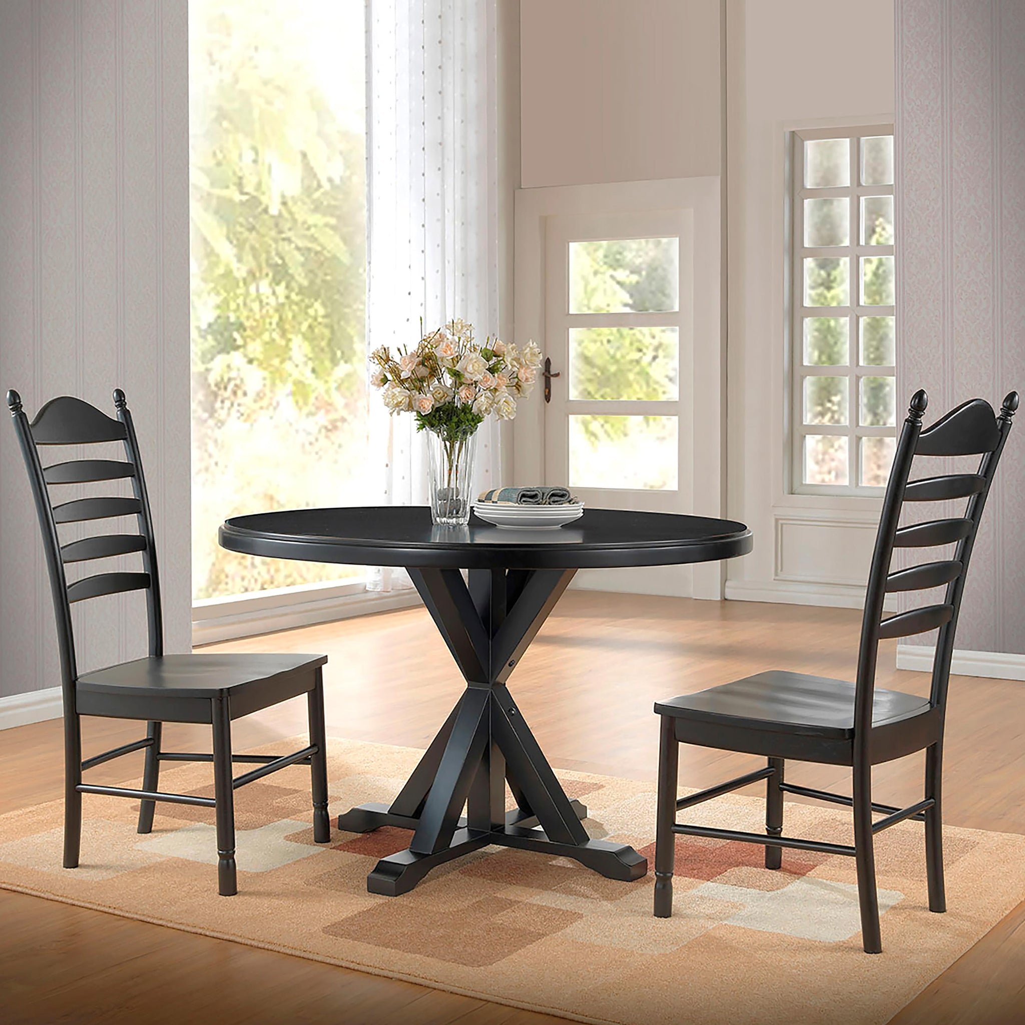 Round trestle dining table surrounded by matching wooden chairs.