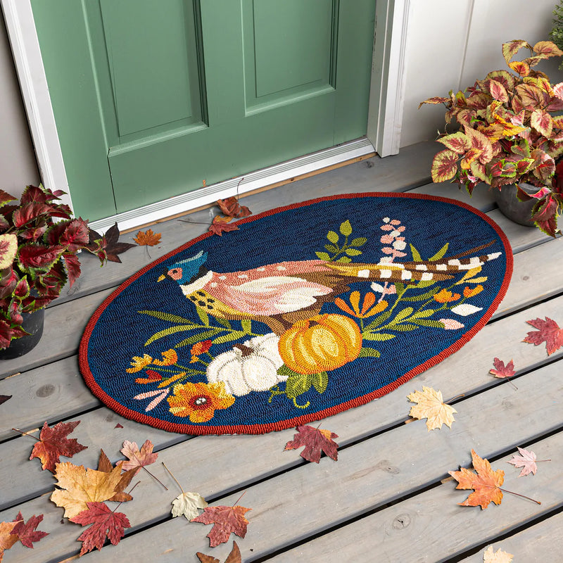 Decorative doormat with autumn design on a wooden porch