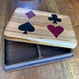 Wooden coaster set with playing card suits on a wooden surface