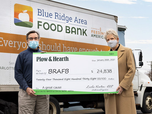 Pictured: Michael McKee, CEO of BRAFB accepts the donation from Leslie Newton, Plow & Hearth CEO