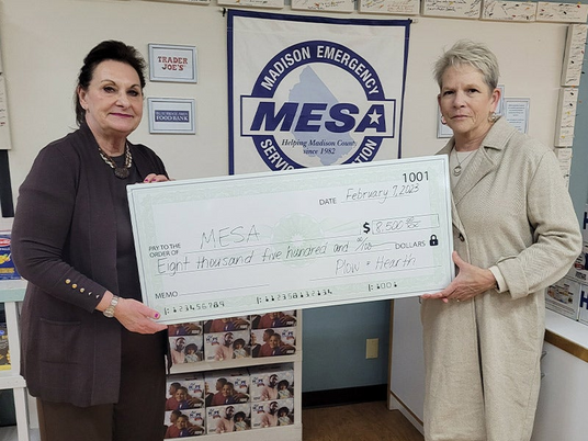 Pictured: Eleanor Mower (left), Executive Director of MESA accepts the donation from Leslie Newton, Plow & Hearth CEO