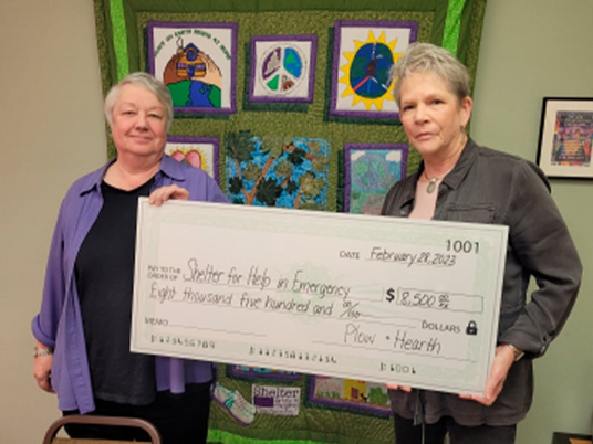 Pictured: Plow & Hearth CEO Leslie Newton presents the donation to Sarah Ellis, Fundraising & Development Coordinator for Shelter for Help in Emergency