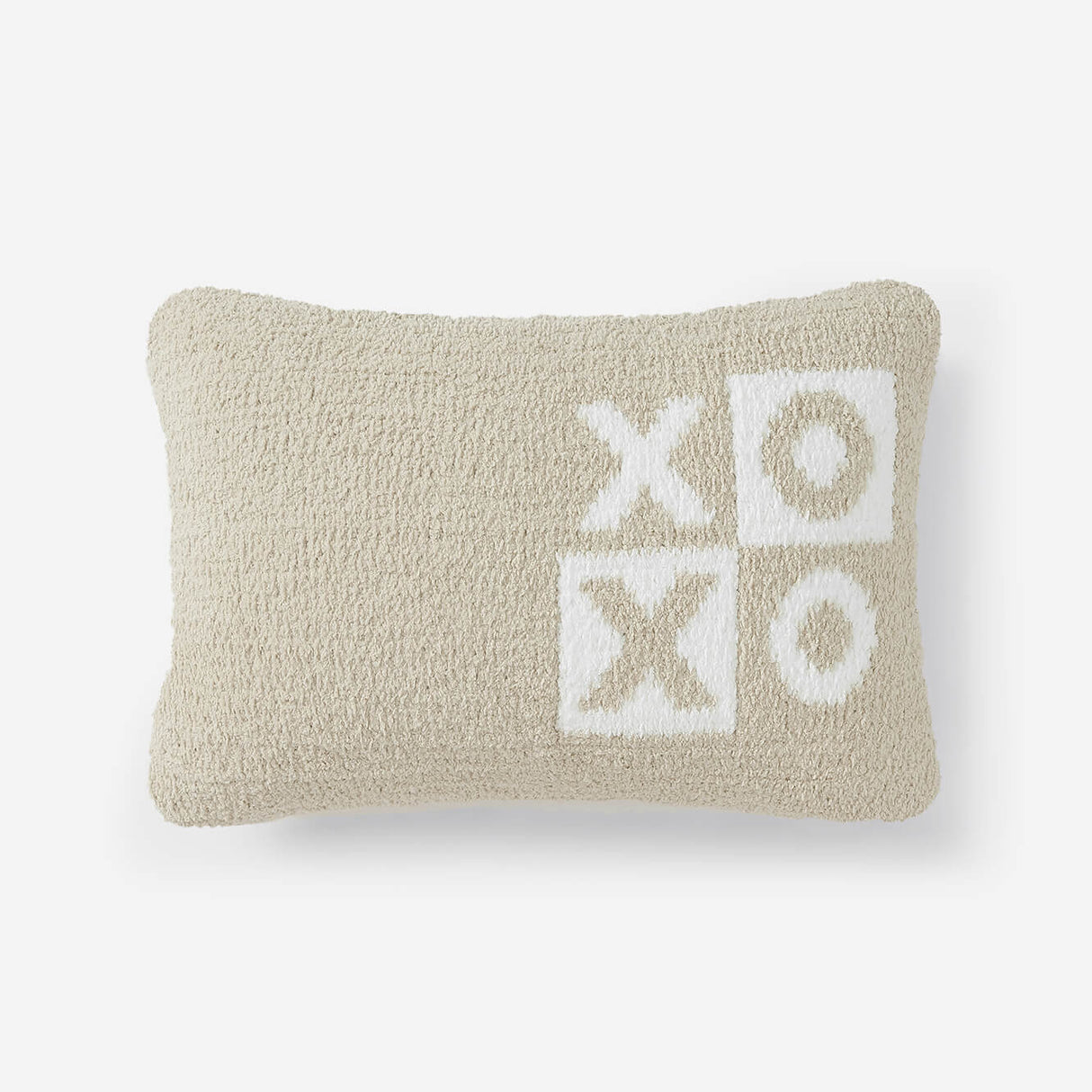 Beige pillow with 'XO' pattern on a white background