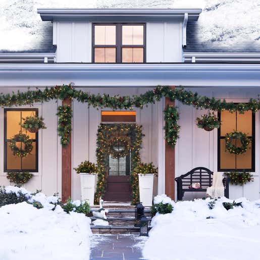 Image of Blue Ridge Pre-Lit Holiday Greenery on a Porch. Shop Wreaths & Garlands