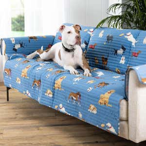 A dog lounging on a sofa covered with a dog-themed sofa cover. Shop Gifts for Pet Lovers >