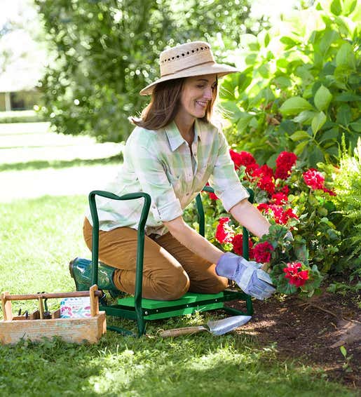 Image of a woman planting flowers while using a Green Garden Kneeler. Shop Gifts for Gardeners